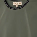 Cloudline Long Sleeve Top in Clover – Close-Up of Neckline and VALA Logo Detail