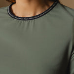 Cloudline Long Sleeve Top in Clover – Close-Up of Collar and VALA Logo Detail