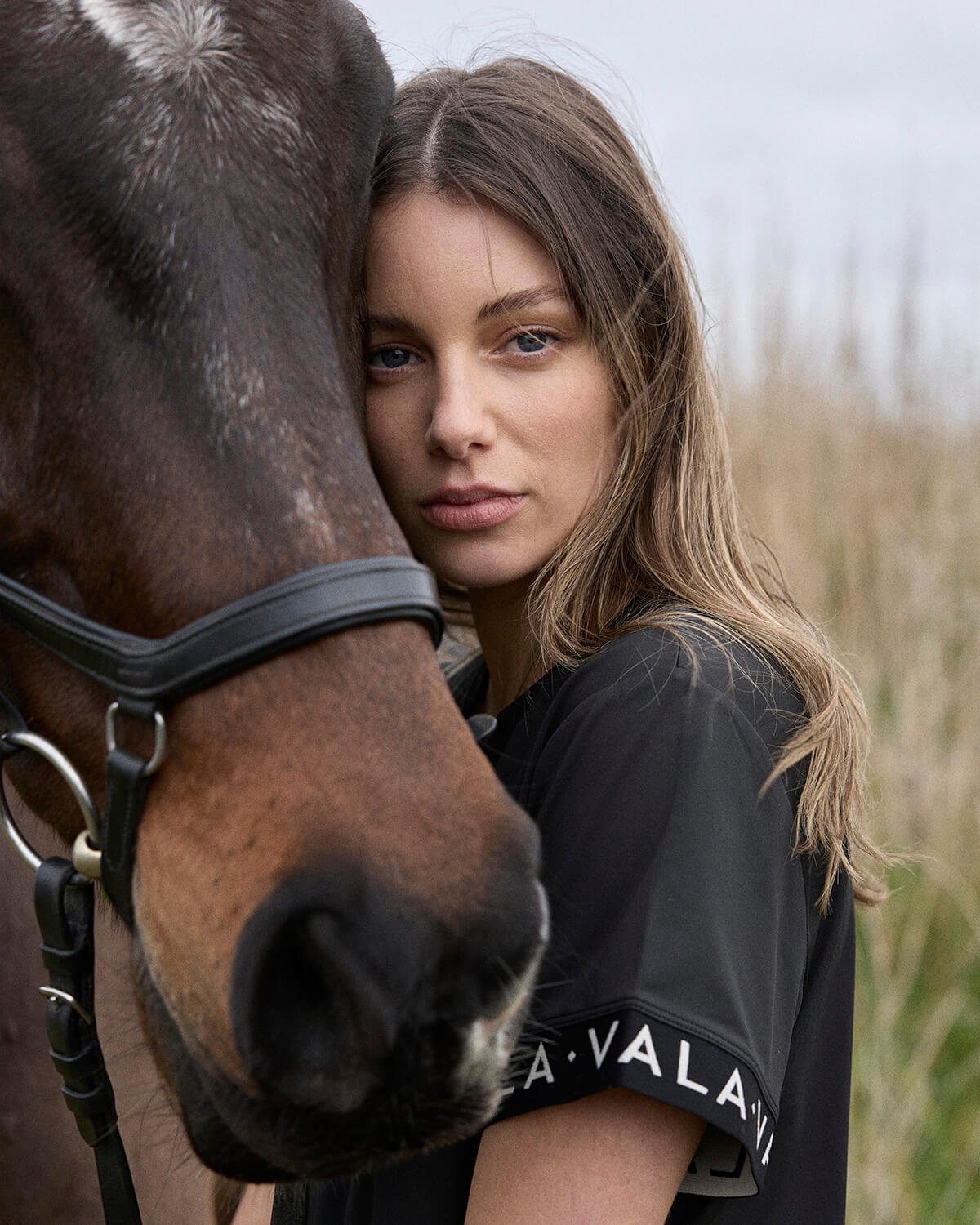 Woman with horse wearing Vala Equestrian apparel 