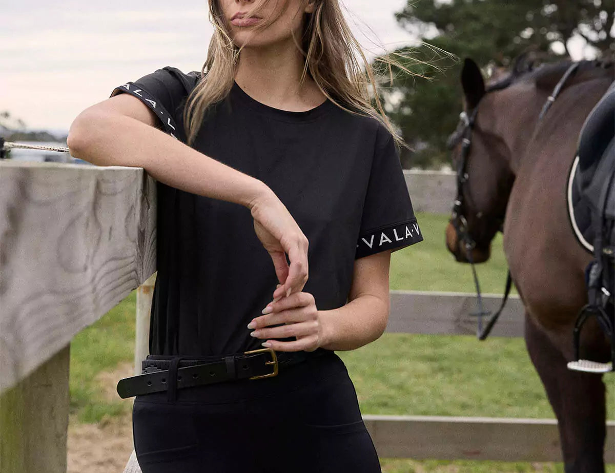 Young woman wearing a black horse riding t shirt 